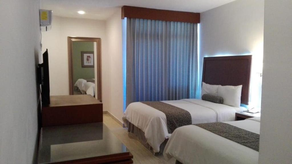 Postel nebo postele na pokoji v ubytování Hotel Marlon