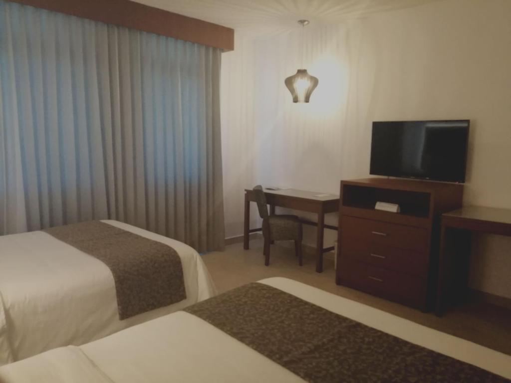 Postel nebo postele na pokoji v ubytování Hotel Marlon