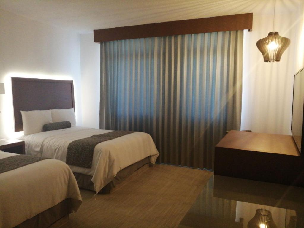 Postel nebo postele na pokoji v ubytování Hotel Marlon