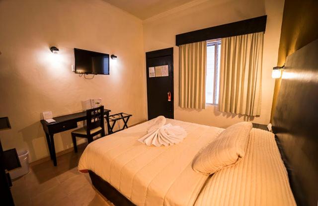 Postel nebo postele na pokoji v ubytování Hotel Marlon