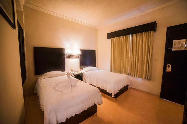 Postel nebo postele na pokoji v ubytování Hotel Marlon