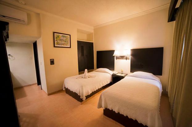 Postel nebo postele na pokoji v ubytování Hotel Marlon