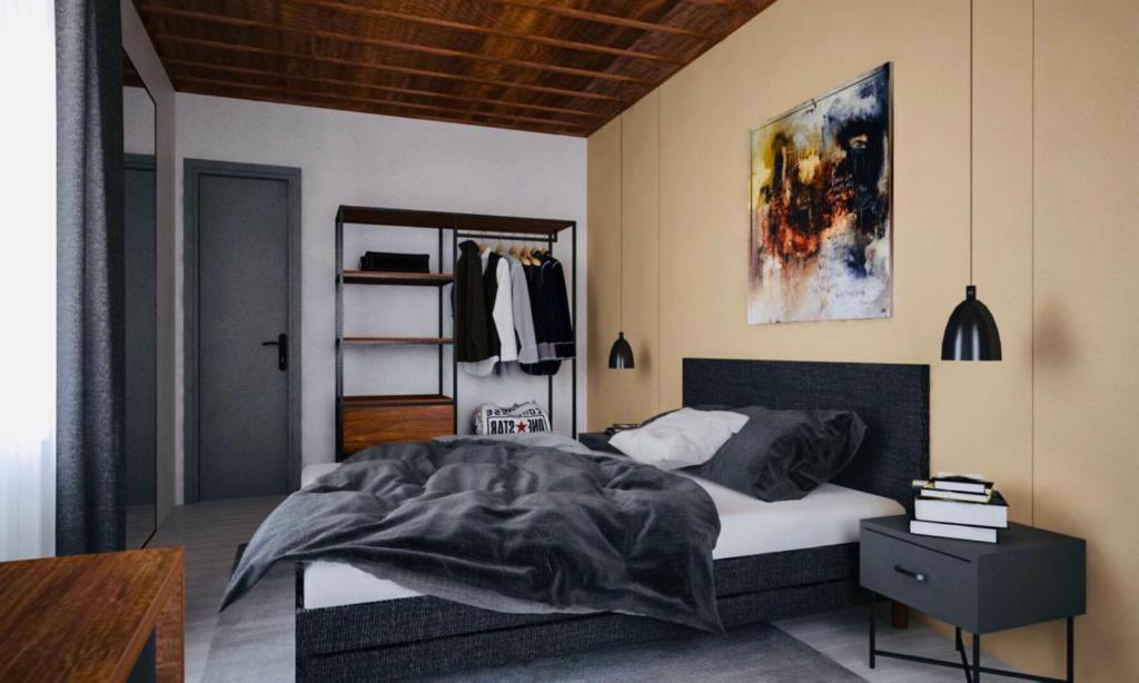 a bedroom with a bed with a black and white comforter at Hotel Boutique Taverne zum Kreuz in Winterthur