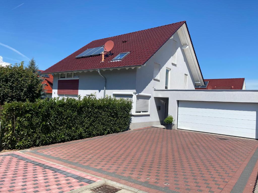 a brick driveway in front of a white house at Ferienwohnung Müller in Lahr