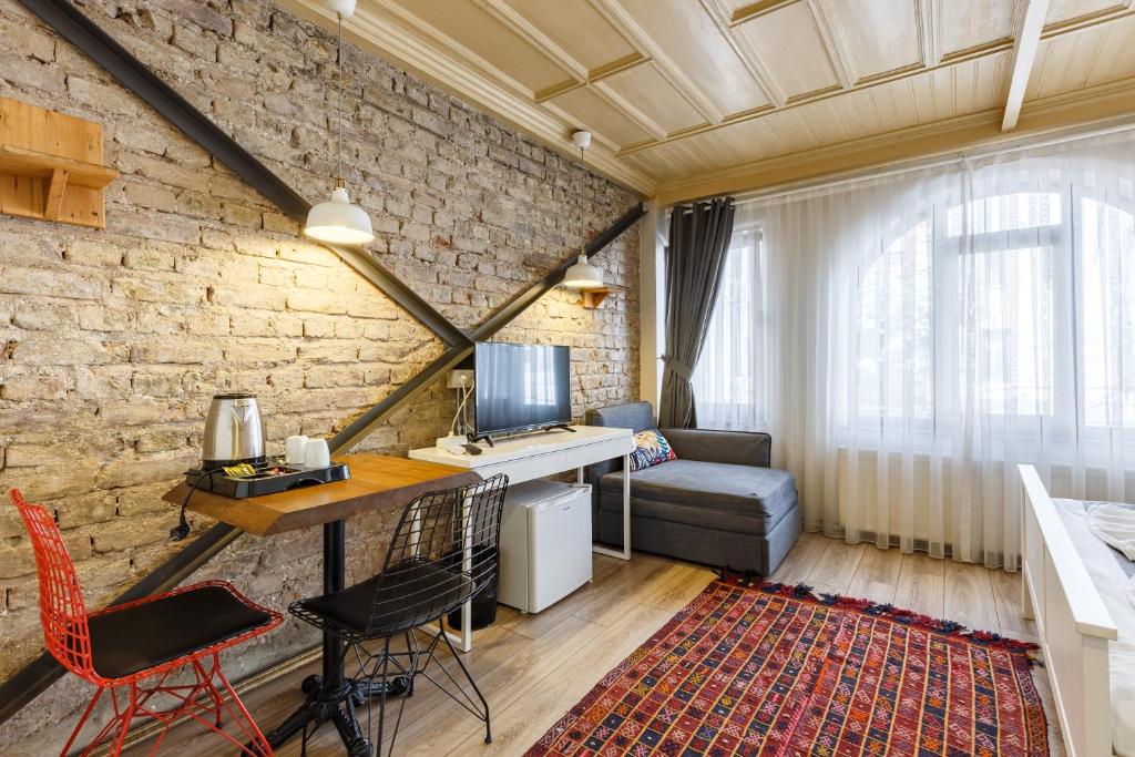 a room with a desk with a computer and a couch at Hotel Miro Mansion Old City in Istanbul