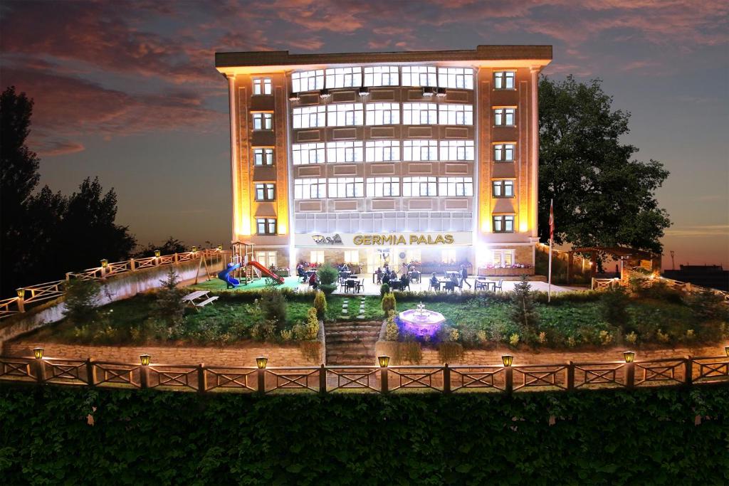 a building with a fountain in front of it at SAFRAN GERMİA PALaS in Bostanbükü