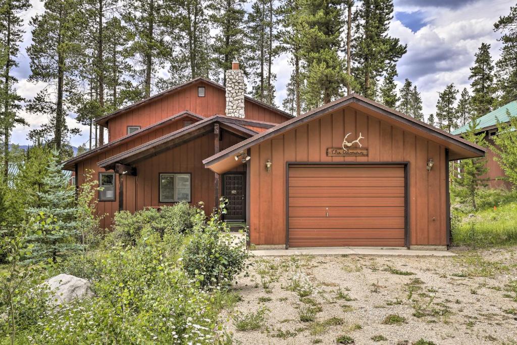 a house with a garage in front of it at Rustic Cabin with Fireplace - 2 Mi to Grand Lake! in Grand Lake