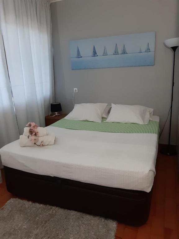 a bedroom with a bed with a stuffed animal on it at Apartamentos Matur in Machico