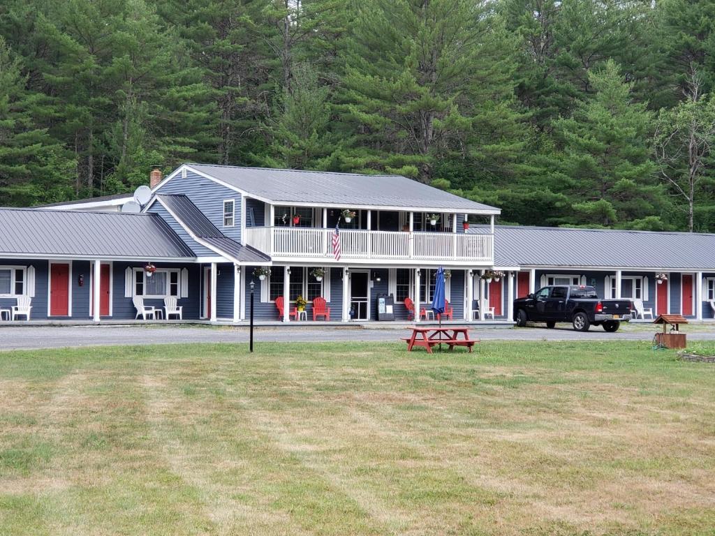 a large house with a truck parked in front of it at Blue Ridge Motel in Schroon Lake