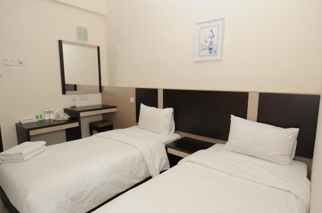 Postel nebo postele na pokoji v ubytování ND Hotel Melaka