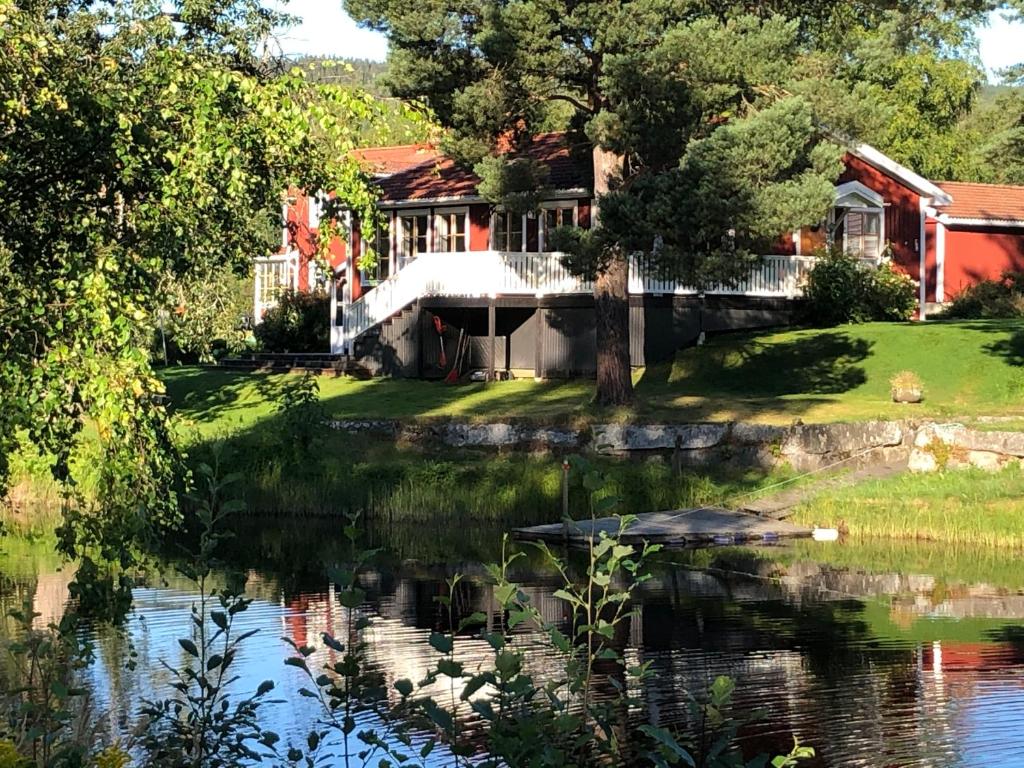 una casa con un estanque delante de ella en Strandvägen 6B Stig en Järvsö