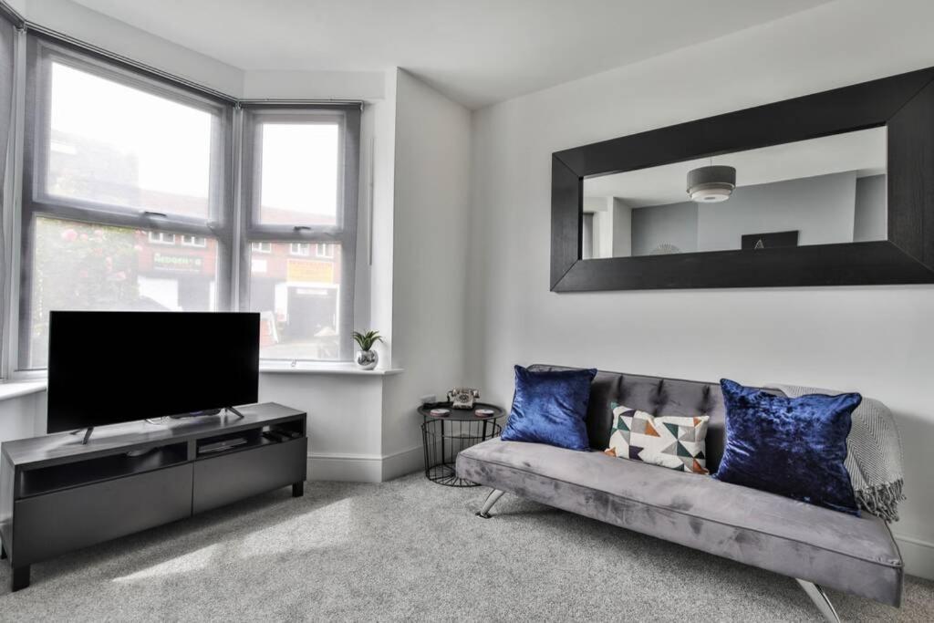a living room with a couch and a flat screen tv at Refurbished Plush Property Great Transport Links in Sheffield