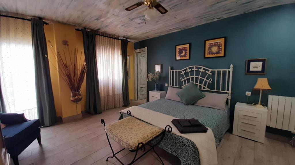 a bedroom with a bed and a blue wall at Casa solis in Leganés