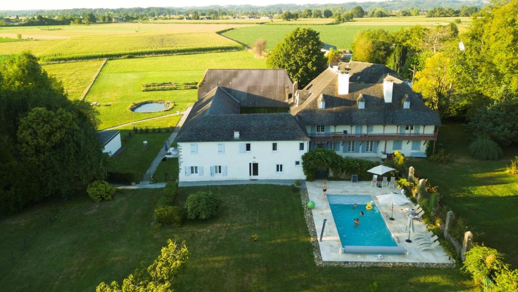 een luchtzicht op een groot huis met een zwembad bij Gîtes L'Escargot Bleu in Oloron-Sainte-Marie