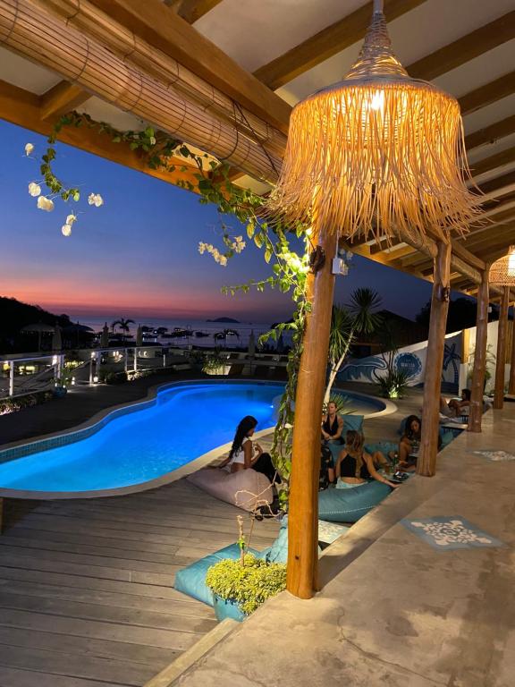 a resort with a swimming pool at night at Seaesta Komodo Hostel & Hotel in Labuan Bajo