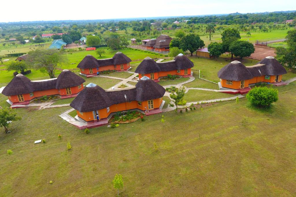 an overhead view of a group of houses with thatched roofs at Acaki Lodge in Kitgum