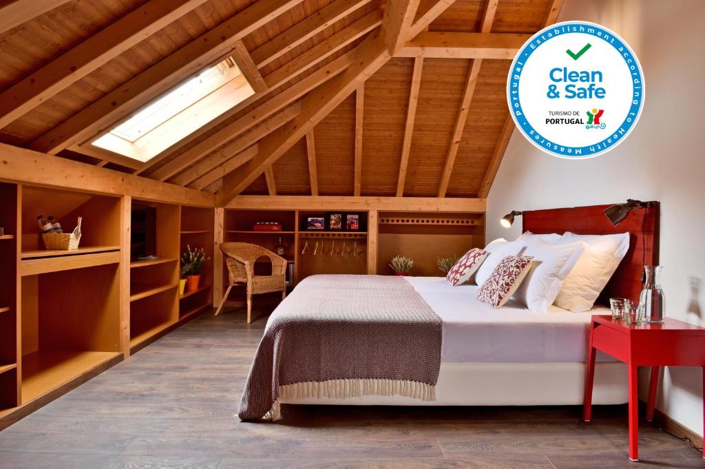 a bedroom with a bed and a skylight at Mercearia D'Alegria Boutique B&B in Peniche