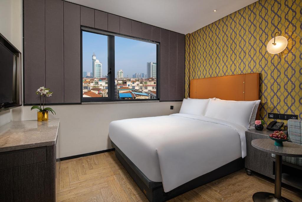 Postel nebo postele na pokoji v ubytování Kasion Pugis Hotel