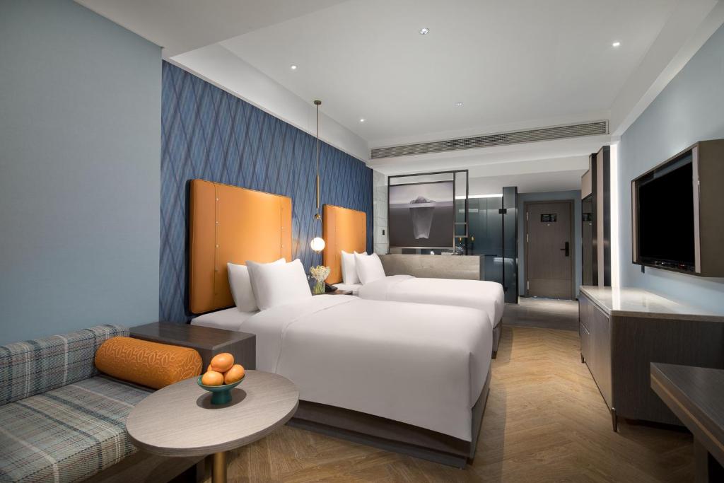 Postel nebo postele na pokoji v ubytování Kasion Pugis Hotel