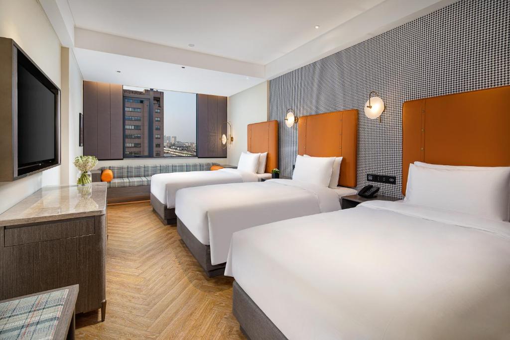 Postel nebo postele na pokoji v ubytování Kasion Pugis Hotel