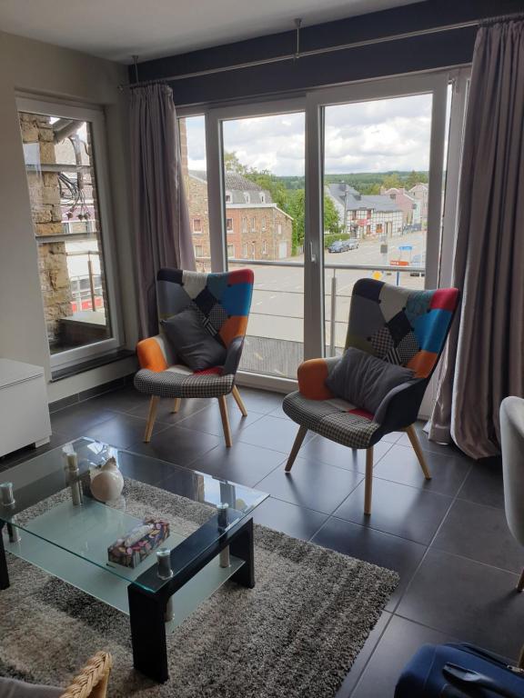 a living room with two chairs and a table at Li Mangon in Francorchamps