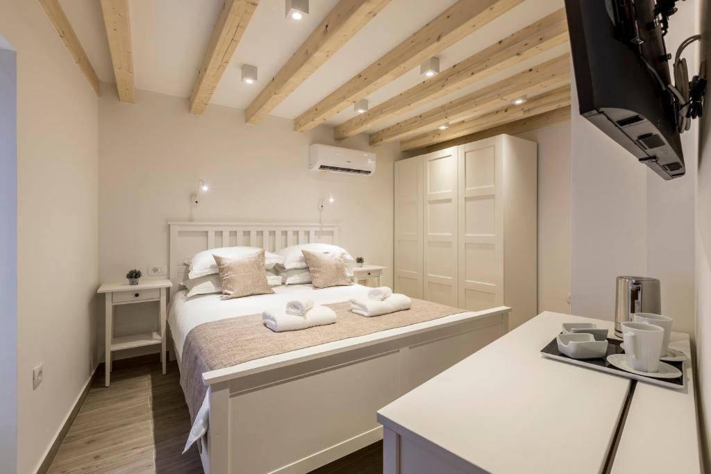 a bedroom with a bed with two towels on it at Cosmijeva Luxury Rooms in Split