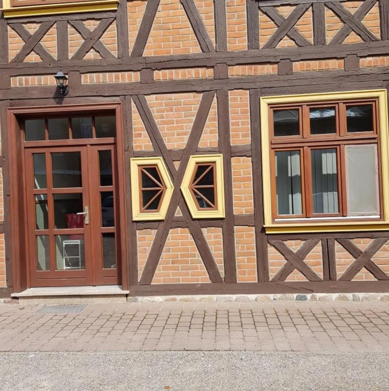 a building with two windows on the side of it at Gasthaus Kristall in Salzwedel