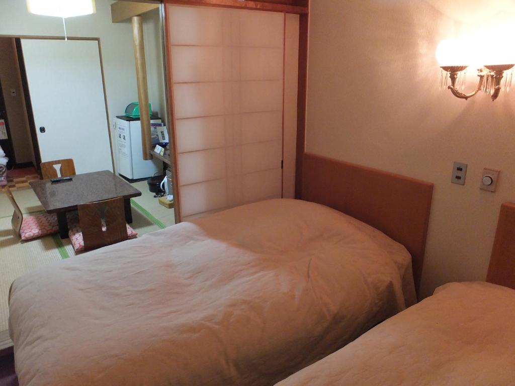 Postel nebo postele na pokoji v ubytování Akakura Wakui Hotel