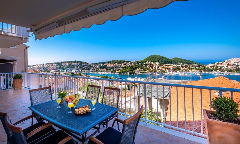 a blue table on a balcony with a view of the water at Villa Gaga in Dubrovnik