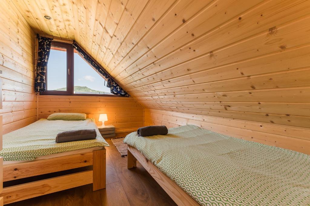 Postel nebo postele na pokoji v ubytování CHATY TRZY