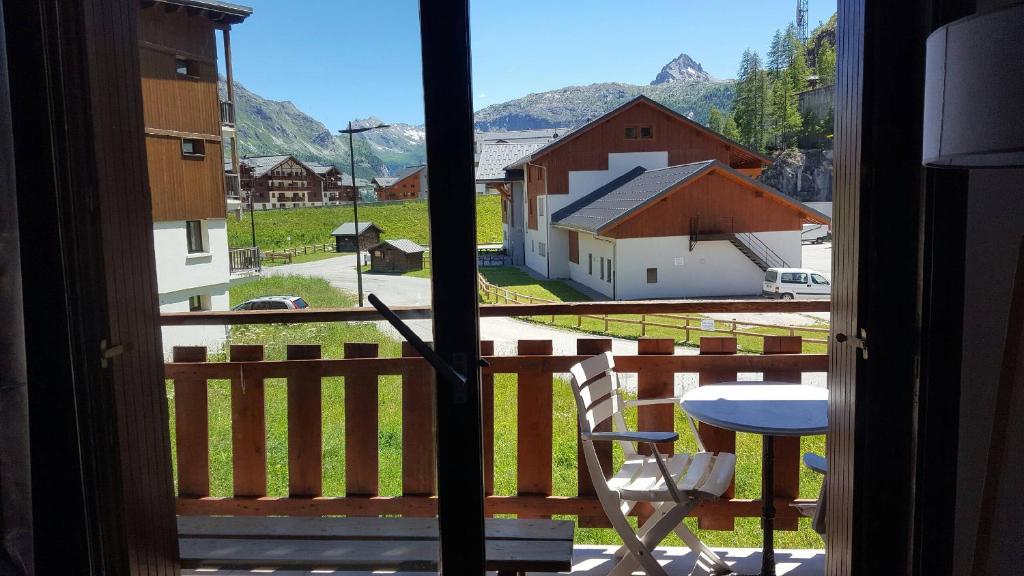 a view from a window with a chair and a table at Tignes 1800 in Tignes