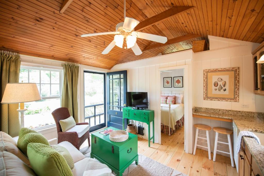 a living room with a couch and a ceiling fan at The Cottages at Cabot Cove in Kennebunkport
