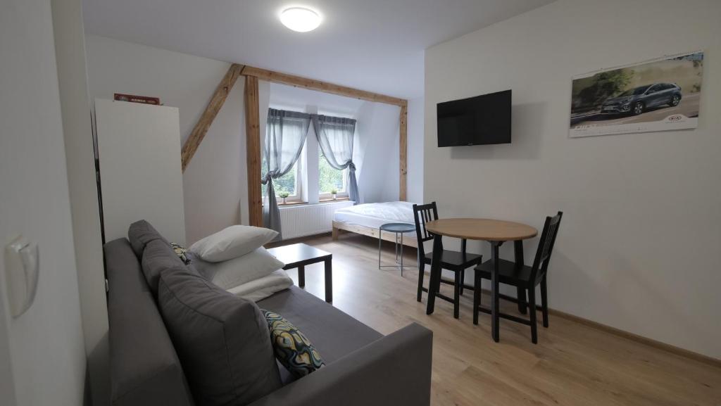 a living room filled with furniture and a tv at Joyful Apartments Sopot in Sopot