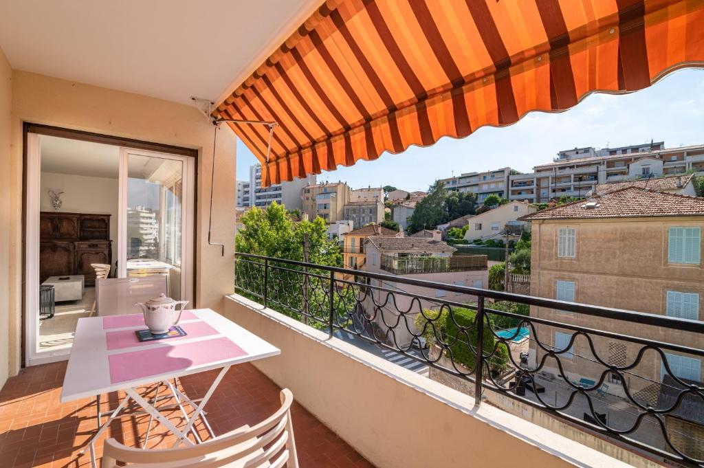 a balcony with a table and a view of a city at COPACABANA appartement 2 chambres in Cannes