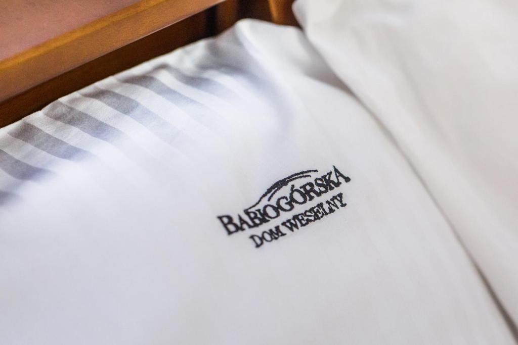 a close up of a white shirt on a bed at BABIOGÓRSKA B&B in Zubrzyca Górna