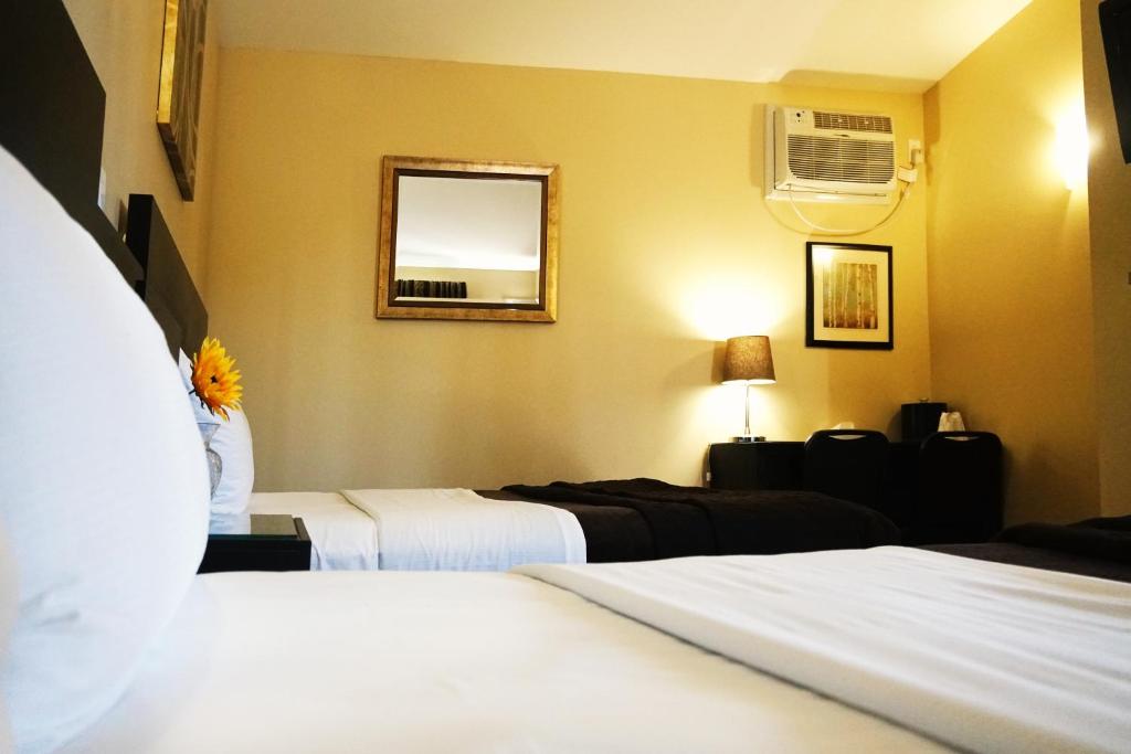 Postel nebo postele na pokoji v ubytování Motel des Cèdres