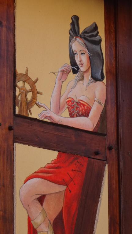 una pintura de una mujer hablando por teléfono en Gite Le Petit Moulin, en Rosenwiller