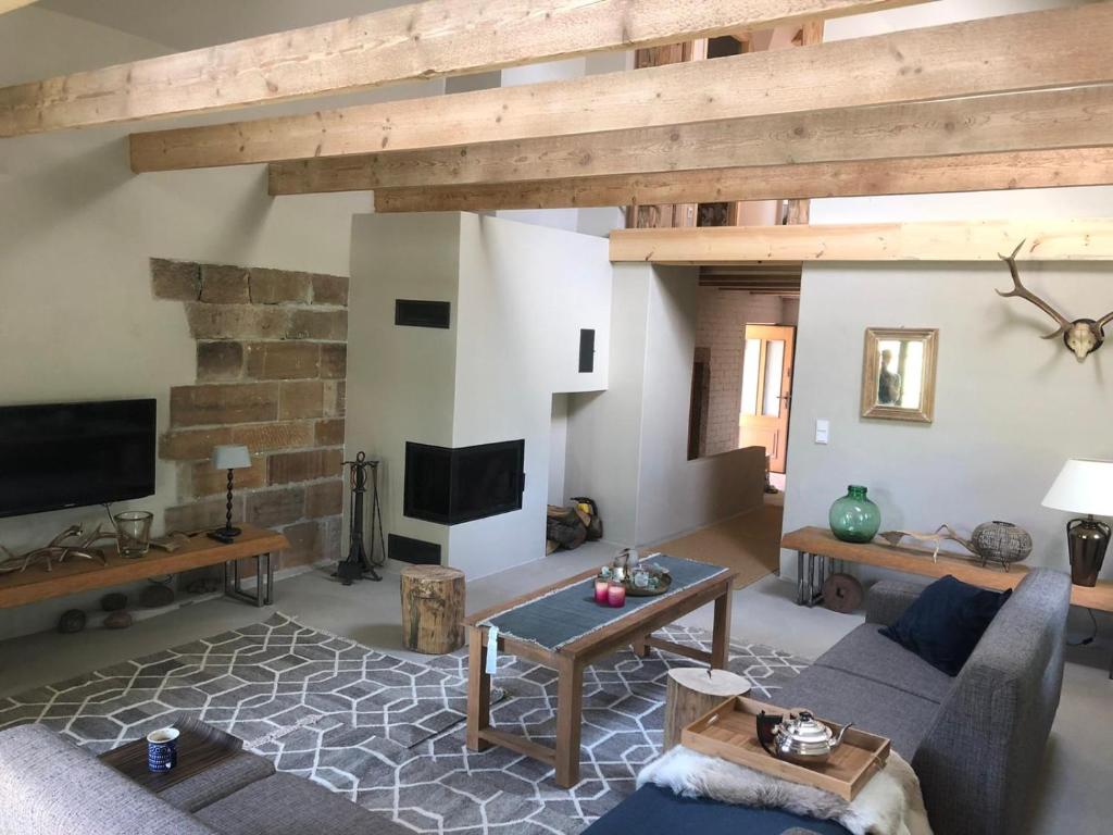 a living room with a couch and a table at Dom Kopaczówka - sauna, home spa in Wünschelburg