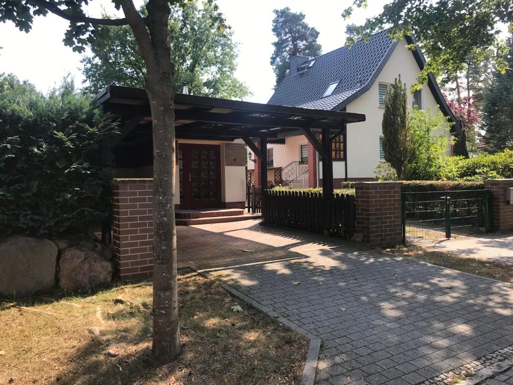 a house with a pavilion in front of it at Ferienhaus an den Moorwiesen in Bad Saarow