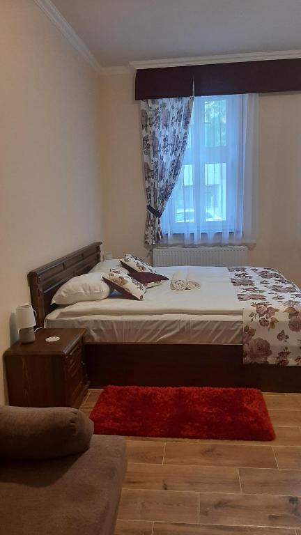 Posteľ alebo postele v izbe v ubytovaní Toscana Apartman
