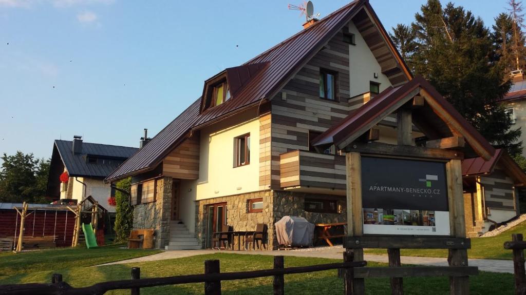 a large house with a gambrel roof at Apartmány Benecko 155 in Benecko