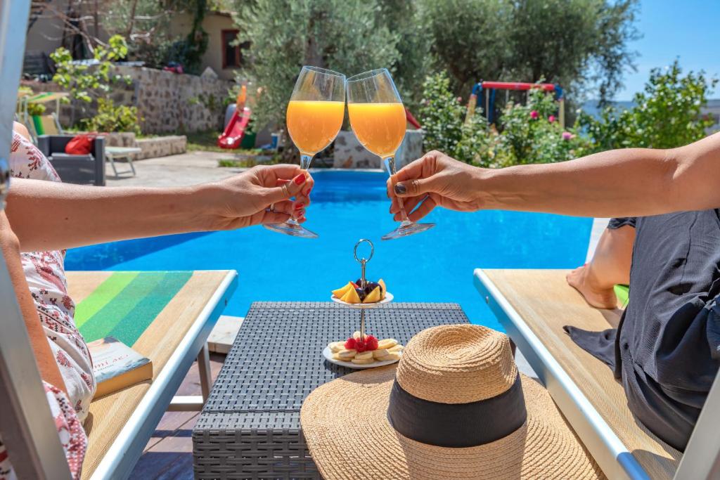 a group of people holding glasses of wine near a pool at Apartments My Przno in Sveti Stefan