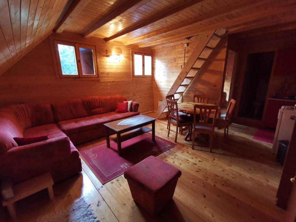 un soggiorno con divano e una scala in una cabina di Apartman Bugar a Mitrovac