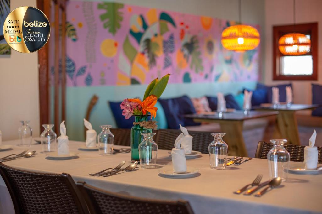 a table with a white table cloth and a vase of flowers at Portofino Beach Resort-An Authentic Island Escape! in San Pedro