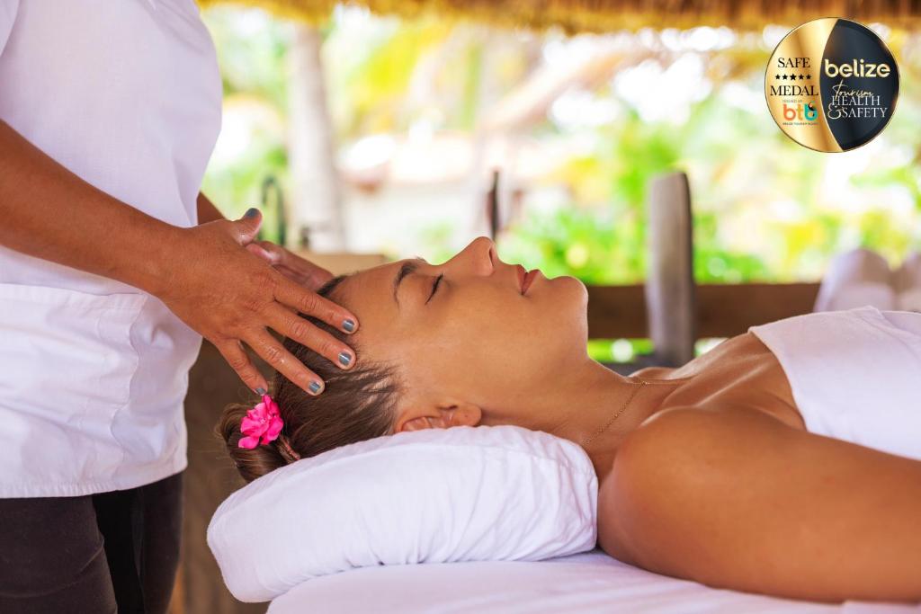 a woman getting a massage from a therapist at Portofino Beach Resort-An Authentic Island Escape! in San Pedro