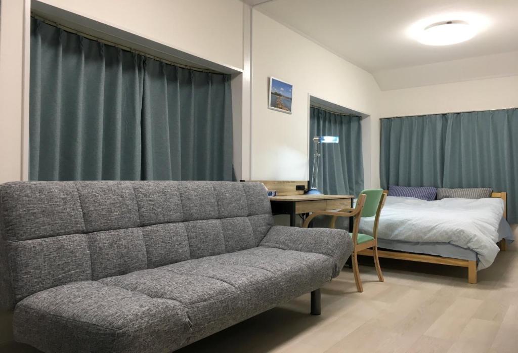 a living room with a couch and a bed at Yokohama - House - Vacation STAY 9002 in Yokohama