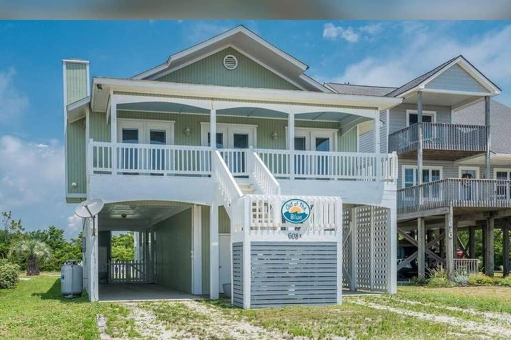 a large house with a porch and a balcony at Donovan's Out of the Blue in Oak Island