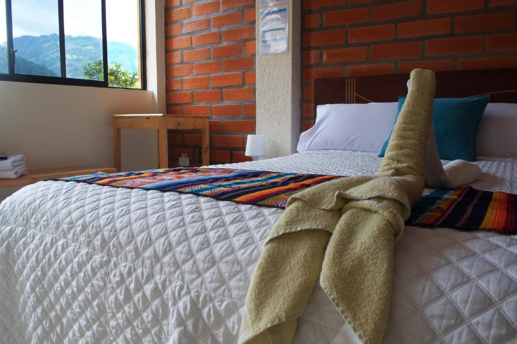 Postel nebo postele na pokoji v ubytování Hostal Monte Carmelo