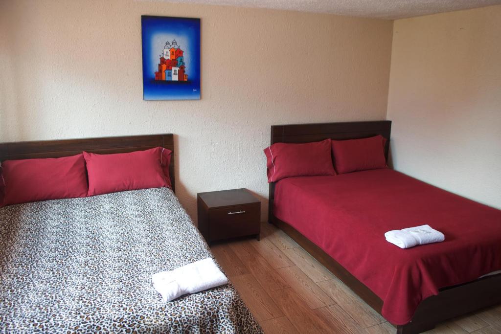 Postel nebo postele na pokoji v ubytování Hostal Monte Carmelo