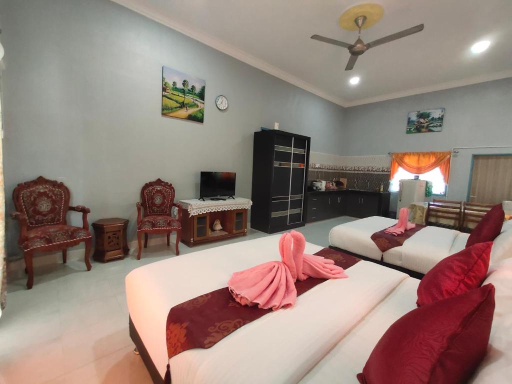 Postel nebo postele na pokoji v ubytování Ku's Roomstay